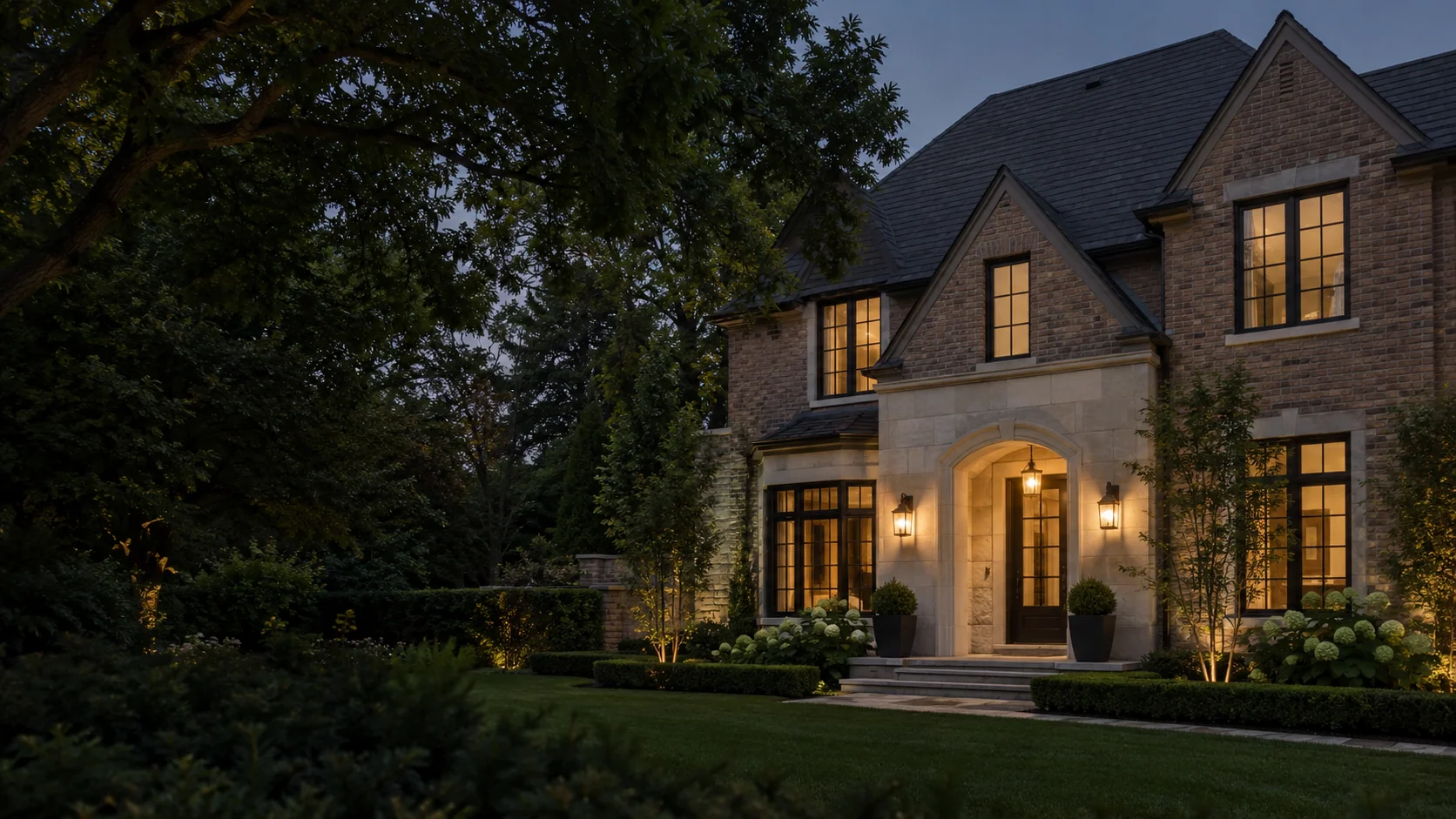 Illustrative brick and limestone townhouse at dusk